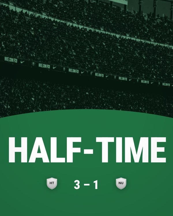 A half-time card, the score on a curved band over a floodlit pitch.